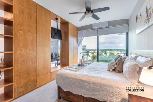 a bedroom with a large bed with a large window at Nuevo Estudio en Aria Ocean 609 in Nuevo Vallarta