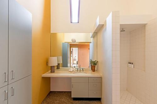 a bathroom with a sink and a mirror at Josh Schweitzer's Monument House Joshua Tree in Joshua Tree