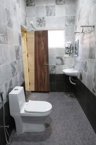 a bathroom with a toilet and a sink at Athulya Resort -Leisure and Luxury cottages from EMBEHolidays in Kottaikadu