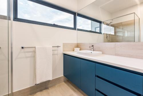 a bathroom with a sink and a mirror at Ocean Blue - Gnarabup NEW in Gnarabup