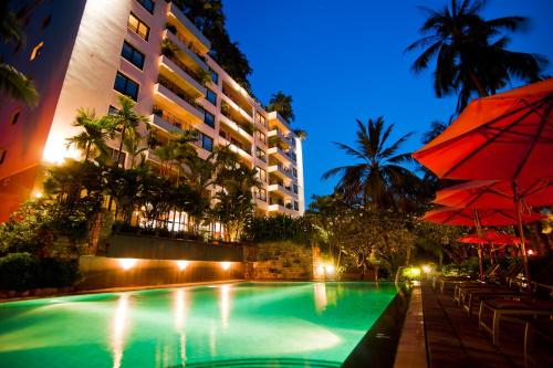 a swimming pool in front of a hotel at night at Saigon Domaine Luxury Residences in Ho Chi Minh City