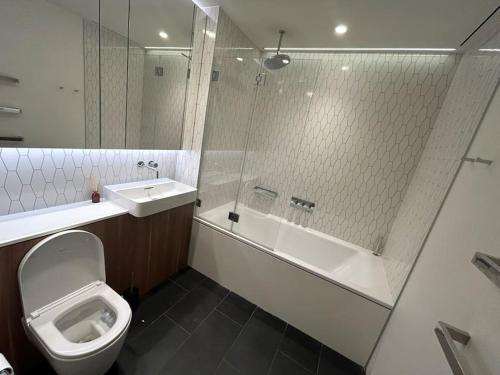 a bathroom with a toilet and a sink and a shower at Luxury 2 Beds Apartment in White city in London