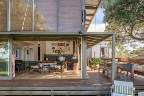 an open patio with a table and chairs at One Hundred Banksias in Culburra Beach