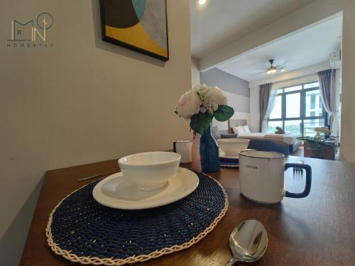 a table with a bowl and a plate on top of it at K Avenue Modern Style Studio (5 Mins to Airport) in Kota Kinabalu
