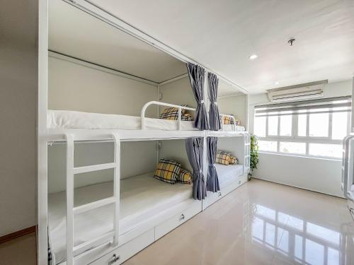 a room with two bunk beds in it at Quoc Cuong Center Da Nang Hotel by Haviland in Da Nang