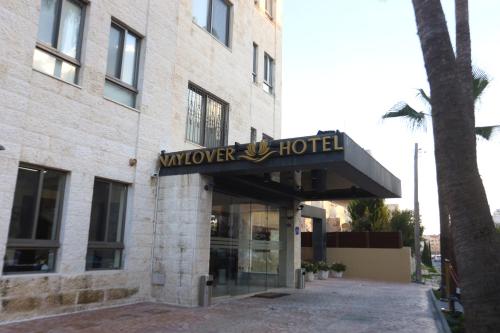 a building with a sign for a wverver hotel at Naylover Hotel Suites in Amman