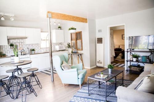 a living room with a blue chair and a table at Seaside Bliss -Downtown! Beach! ConvCenter! Bikes! in Long Beach