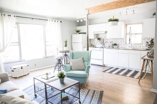 an open kitchen and living room with a blue chair at Seaside Bliss -Downtown! Beach! ConvCenter! Bikes! in Long Beach