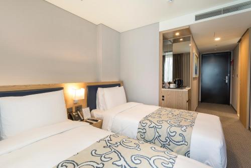 Centum Premier Hotelにあるベッド