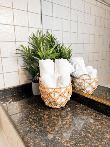 two baskets of toilet paper on a counter in a bathroom at Perfect Family Escape - 3 Bed Condo with Pools in St. George