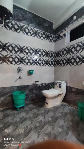 a bathroom with a toilet and a sink at Wood packers in Kasol