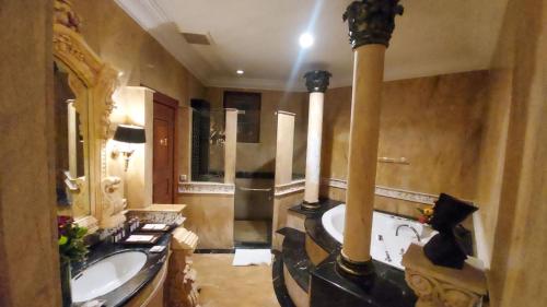 a large bathroom with a tub and a sink at Bali Corner Residence Denpasar in Denpasar