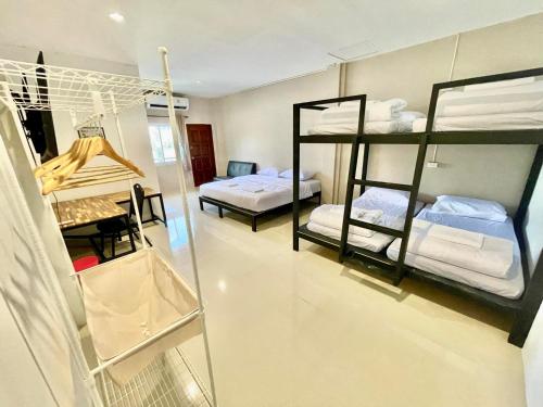 a room with two bunk beds and a room with a room with at Lamoon 90s in Hat Yai