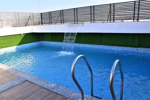 a swimming pool with a water fountain at Hotel Harku Villa in Dabok