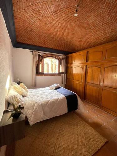 a bedroom with a bed and a window in it at Casa Orquidea in San Miguel de Allende