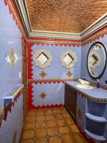 a bathroom with a sink and a mirror at Casa Orquidea in San Miguel de Allende