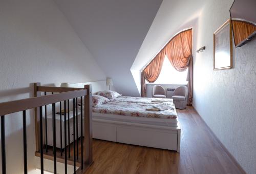 a small bedroom with a bed and a window at Curonian apartments in Nida