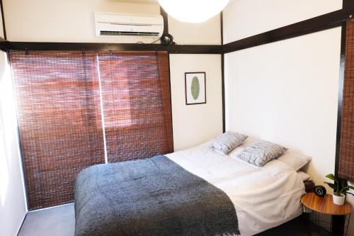 een slaapkamer met een bed en een groot raam bij green park heights - Vacation STAY 15687 in Musashino