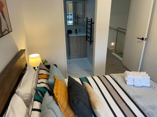 a bedroom with a bed and a bathroom with a sink at Flat Bush Holiday Accomodation in Auckland