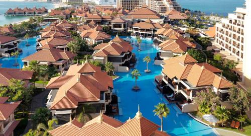 an aerial view of a resort with swimming pools at Royal Amwaj Apartments, Palm Jumeirah, Free beach and pool access in Dubai