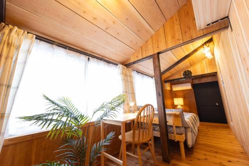 a room with a table and chairs and a window at Guest House Henza in Henza