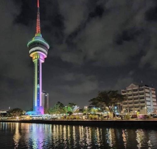 auckland tower lit up at night next to a body of water at Indera Sempurna Ruma Aisya in Kuantan