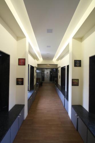 a hallway in a hospital with a long corridor at Hostells in Pune