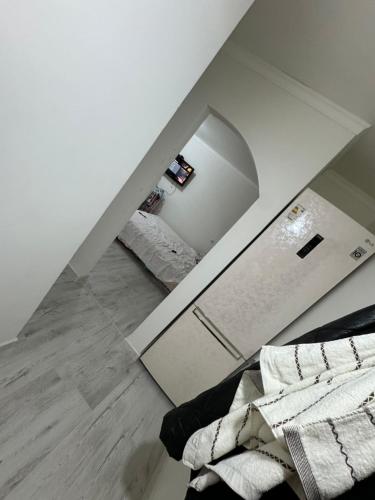 a bedroom with a mirror and a bed in it at Сдается уютная 1 комнатная квартира in Astana
