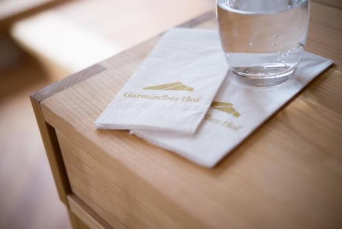 a glass of water sitting on top of a table at Biohotel Garmischer Hof in Garmisch-Partenkirchen