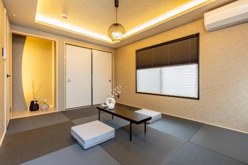 a living room with a table and a window at JAPAVISTA Aqua in Osaka