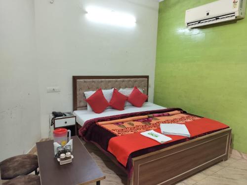 a bedroom with a large bed with red pillows at HOTEL HOLIDAY INN PARADISE in Chandīgarh