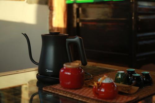 a coffee maker sitting on top of a counter at Playing Again Hostel in Lijiang
