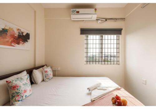 a bedroom with a bed with a air conditioner on it at BluO Park View 1BHK HSR Layout - Terrace Garden in Bengaluru