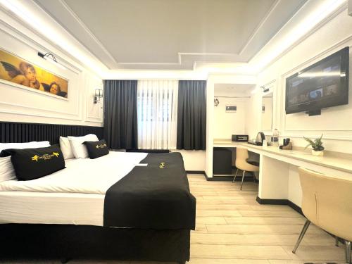 a hotel room with a bed and a desk at Angel's Home Suites - Angel Group Hotels in Istanbul