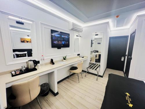 a room with a desk and a tv on the wall at Angel's Home Suites - Angel Group Hotels in Istanbul