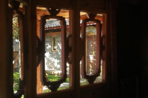 a view through a window of a building at Playing Again Hostel in Lijiang
