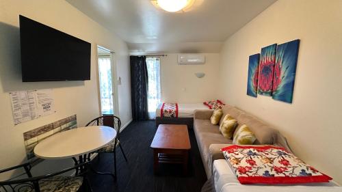 a living room with a couch and a table at Samhil Motor Lodge in Christchurch