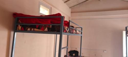 a bedroom with two bunk beds in a room at Saanidhya hostels in Mukteswar