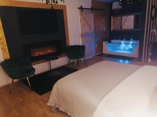 a bedroom with a bed and a fireplace at 7.Nebo/ Spa apartman Vinkovci in Vinkovci