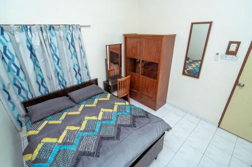 a bedroom with a bed and a mirror at GLYSM Tambun Stay "Pura Vida" in Ipoh