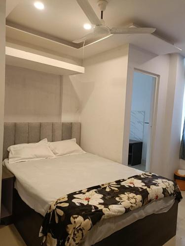 a bedroom with a bed with a ceiling fan at Arnnapurna Hotel & Resort in Jājpur