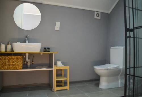 a bathroom with a sink and a toilet at Quonset Glamping in Seferihisar
