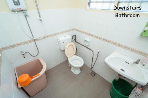 a bathroom with a toilet and a sink at GLYSM Tambun Stay in Ipoh