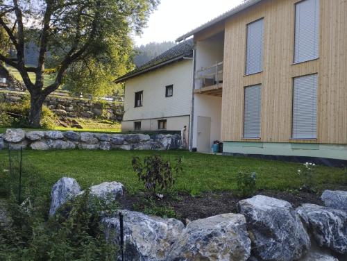 a yard with rocks in front of a house at Haus Abendrot in Dornbirn