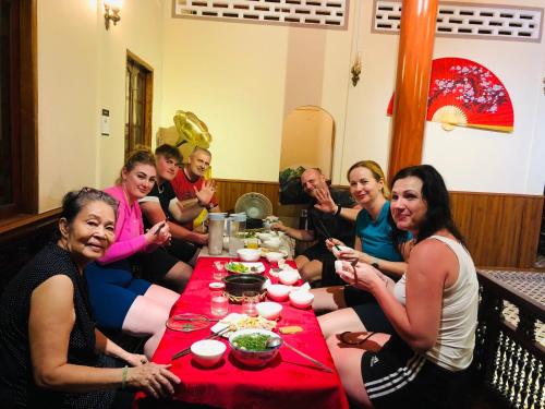 a group of people sitting around a table eating at Cóc Retreat Mỹ Tho City in My Tho