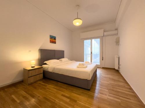 a bedroom with a bed and a large window at Gtrip Nea Smyrni Apartment - 3421 in Athens