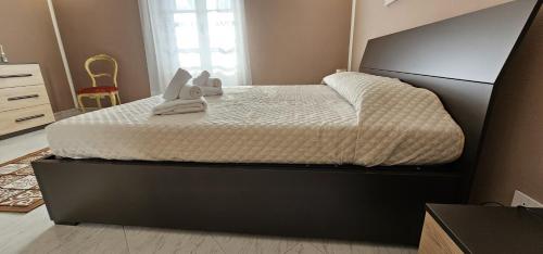a bedroom with a large bed with a black frame at Villa Teresa in Oschiri