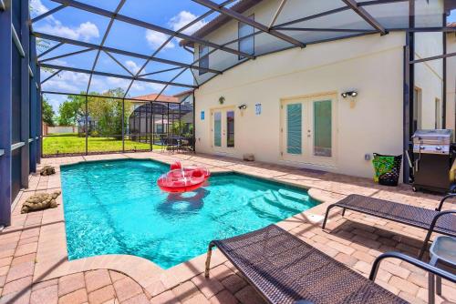 a pool with a red boat in the middle at Spacious 4BR Home Perfect for Families in Orlando