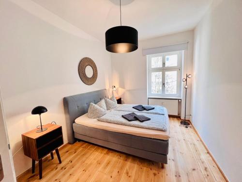 a bedroom with a bed and a table and a window at Central City Cosy Lux in Berlin