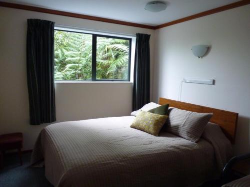 a bedroom with a large bed with a window at Ligita's Homestay in Havelock
